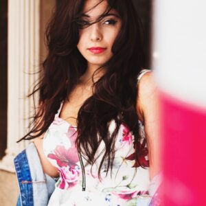 Photo by Mikail Duran shallow focus photography of woman in white, green, and red floral spaghetti strap top